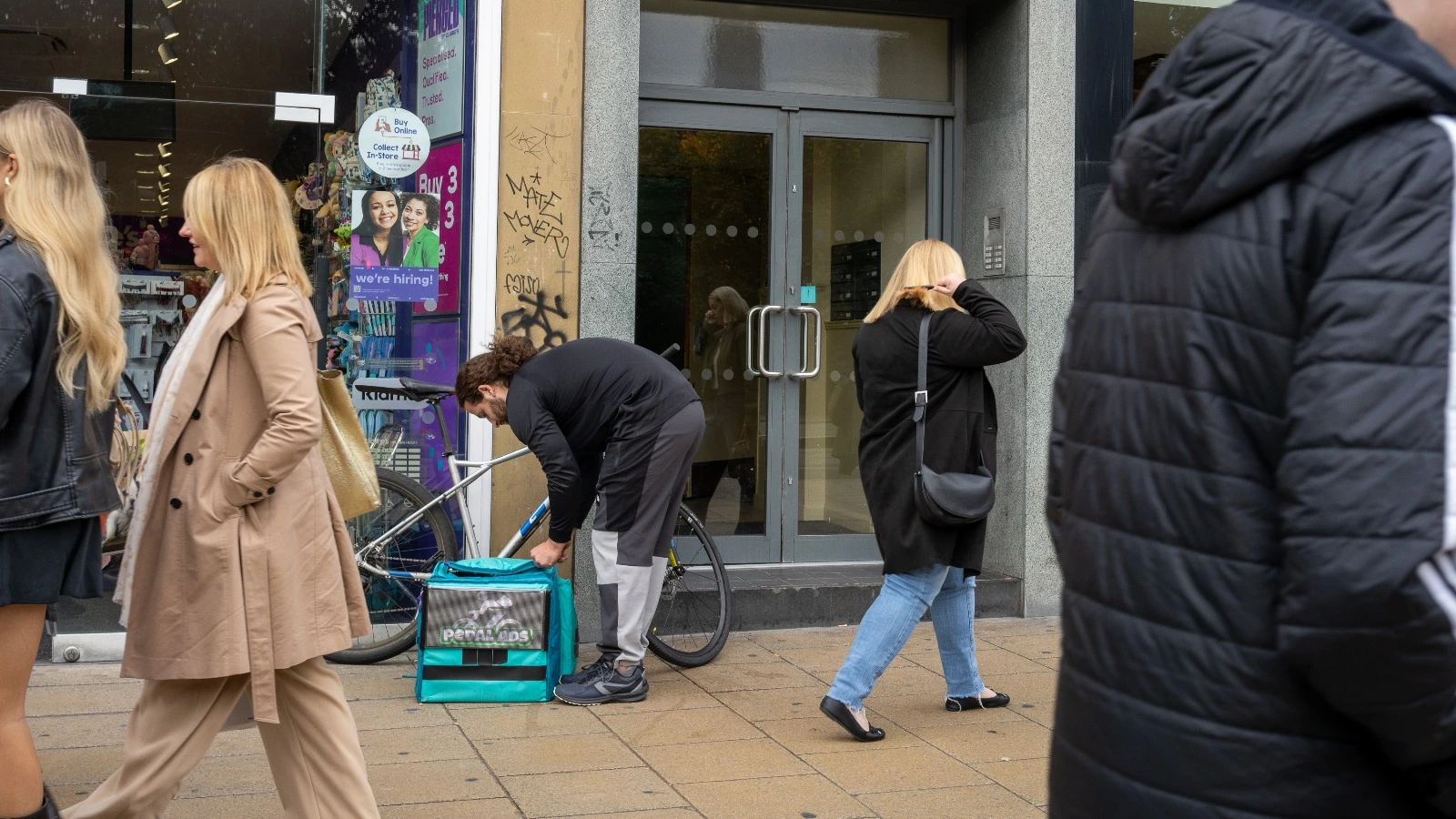 Night view of illuminated advertising display on delivery bike in Edinburgh